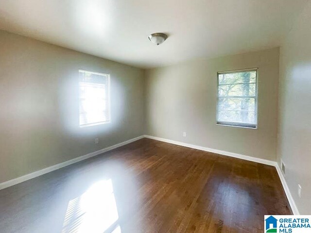 unfurnished room featuring dark hardwood / wood-style floors