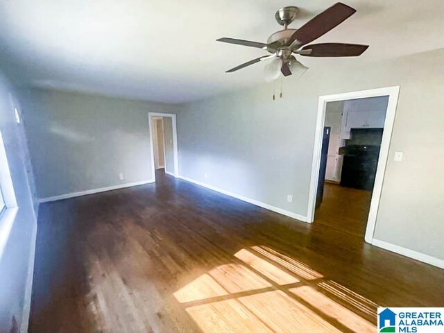 empty room featuring ceiling fan and dark hardwood / wood-style floors