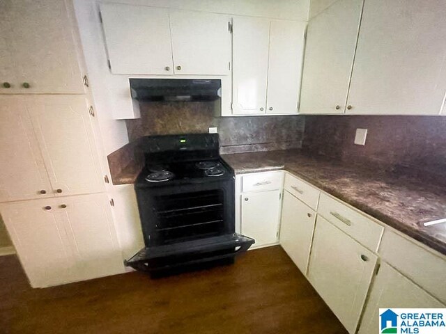 kitchen featuring backsplash, black range, dark hardwood / wood-style flooring, white cabinetry, and extractor fan