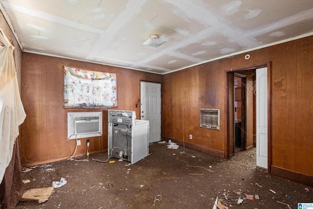 miscellaneous room with an AC wall unit, heating unit, and wooden walls