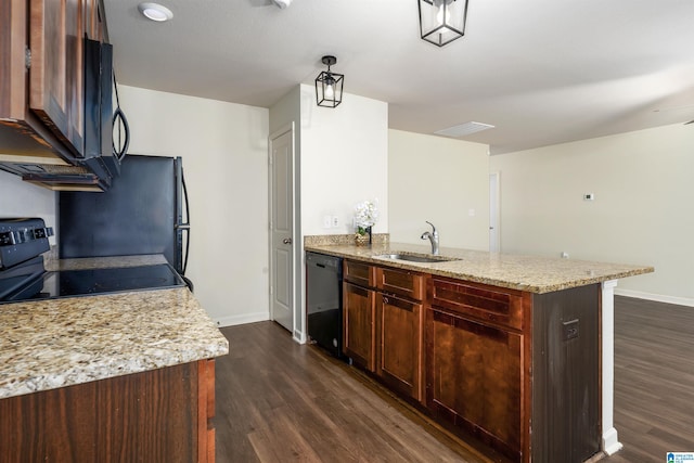 kitchen with black appliances, sink, hanging light fixtures, dark hardwood / wood-style floors, and light stone countertops