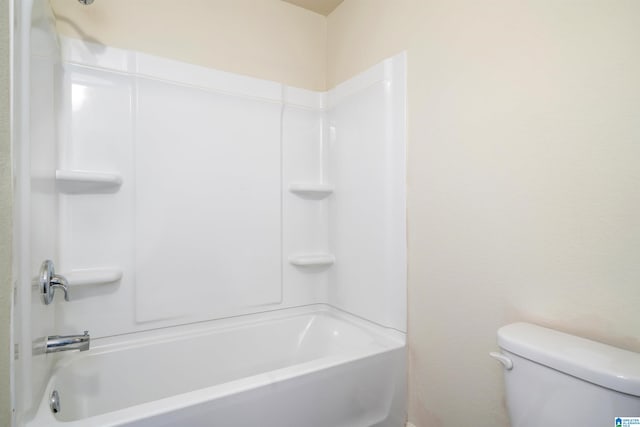 bathroom with bathing tub / shower combination and toilet