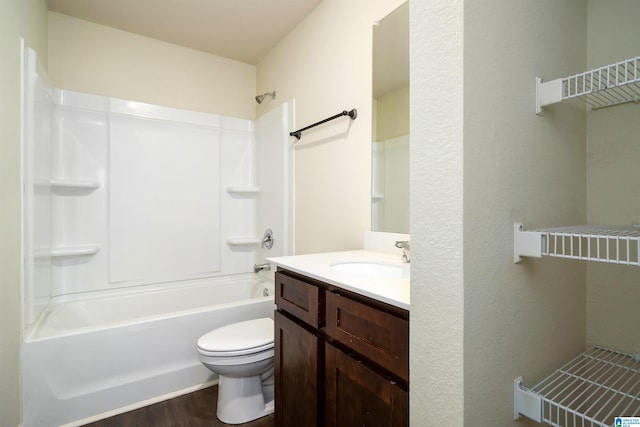 full bathroom featuring hardwood / wood-style flooring, vanity, tub / shower combination, and toilet