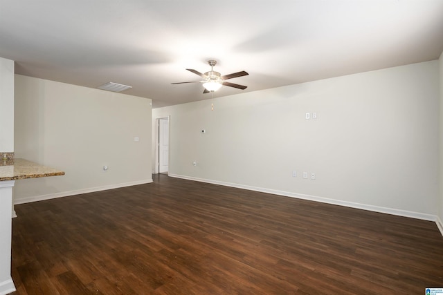 unfurnished living room featuring ceiling fan and dark hardwood / wood-style flooring