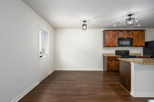 kitchen with light stone countertops, dark hardwood / wood-style floors, and black appliances