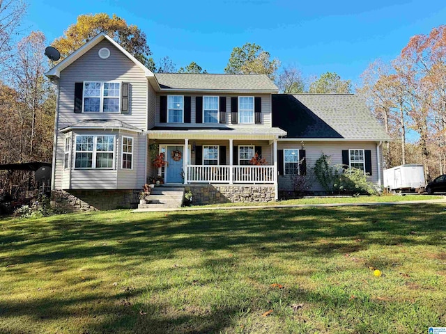 colonial house featuring a porch and a front yard