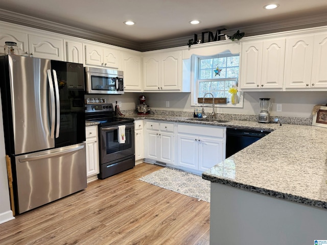 kitchen featuring sink, stainless steel appliances, light hardwood / wood-style flooring, white cabinets, and ornamental molding