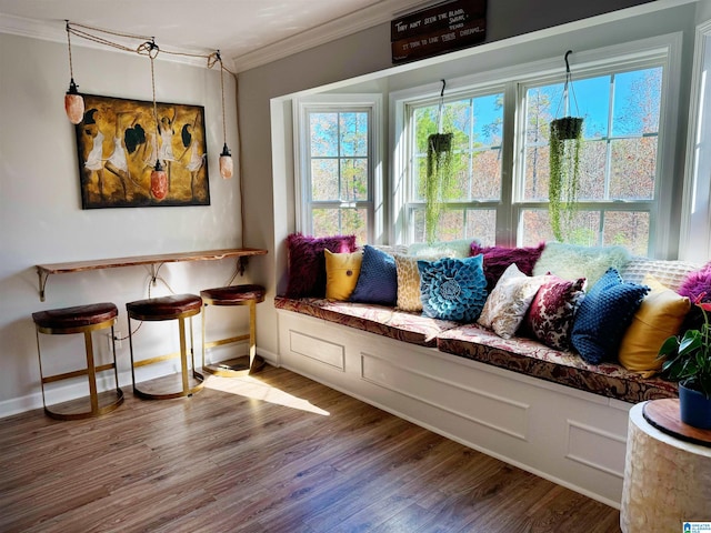 sitting room featuring ornamental molding and hardwood / wood-style flooring