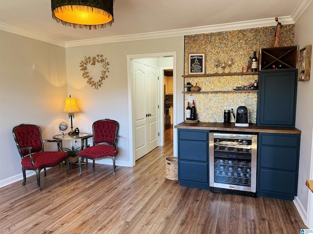 bar with brick wall, blue cabinets, dark wood-type flooring, crown molding, and wine cooler