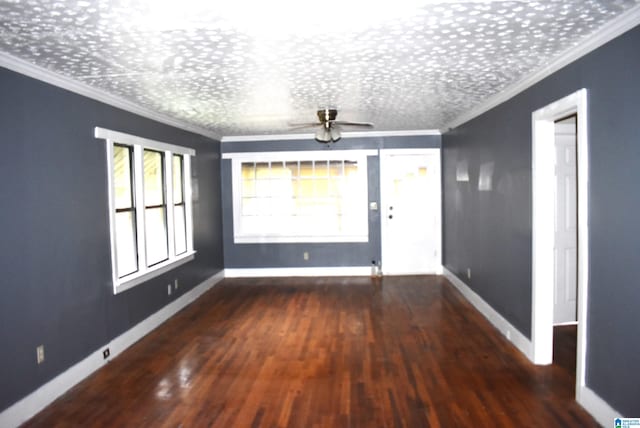 empty room with a textured ceiling, ceiling fan, dark hardwood / wood-style flooring, and crown molding