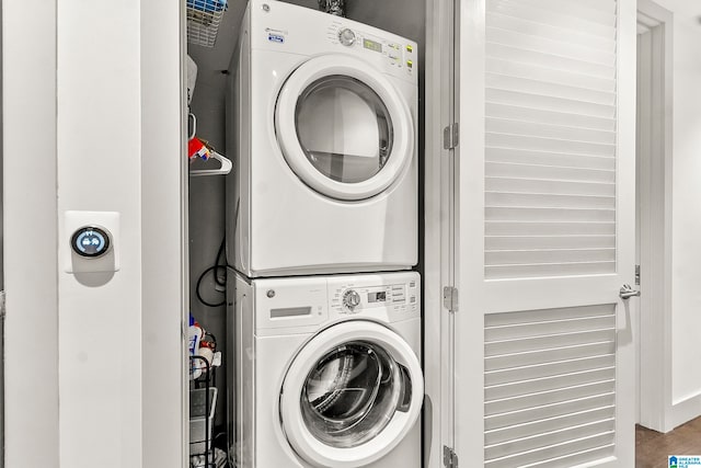 clothes washing area with stacked washer / drying machine