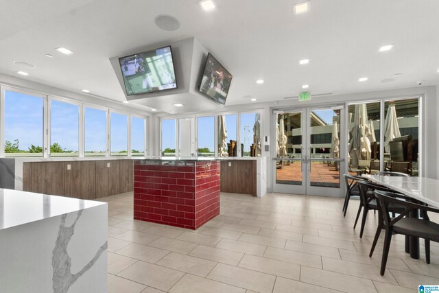 kitchen featuring a center island, light tile patterned floors, and french doors