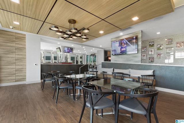 dining area featuring a chandelier, hardwood / wood-style floors, and wood ceiling