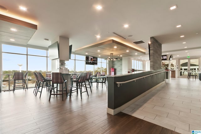 interior space featuring light wood-type flooring and a wall of windows