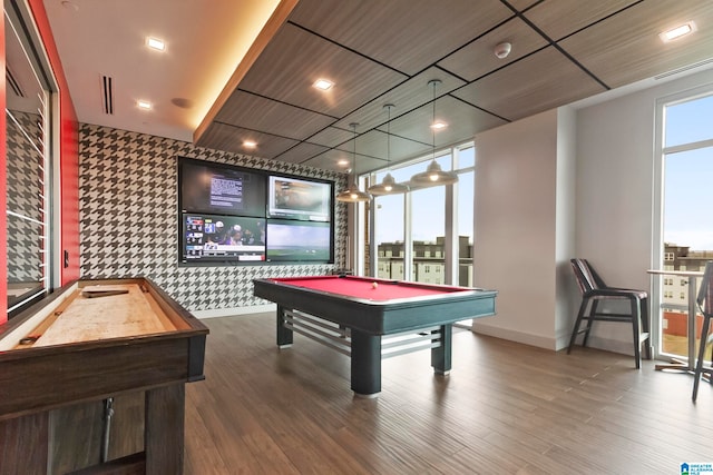 game room with hardwood / wood-style floors, a wealth of natural light, and billiards