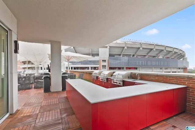 view of patio / terrace with sink, an outdoor kitchen, and a grill