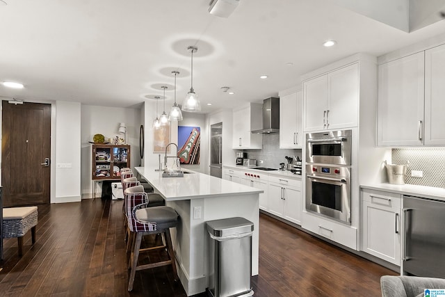 kitchen featuring white cabinetry, wall chimney exhaust hood, and dark wood-type flooring