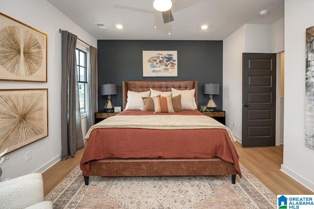 bedroom with light hardwood / wood-style flooring and ceiling fan