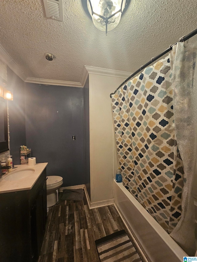 full bathroom with ornamental molding, vanity, a textured ceiling, hardwood / wood-style flooring, and toilet