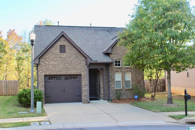 view of front of house with a front yard and a garage