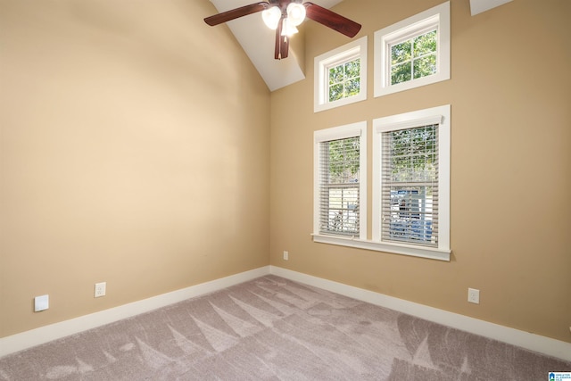 unfurnished room featuring light colored carpet, high vaulted ceiling, and ceiling fan