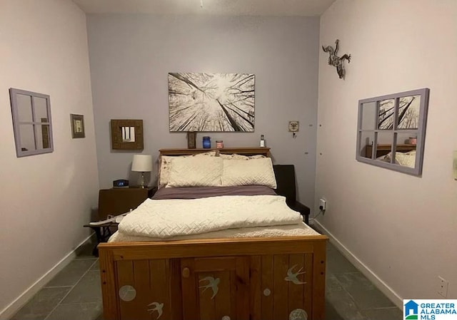 bedroom with dark tile patterned flooring