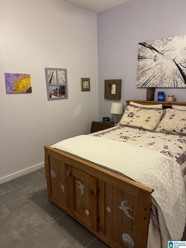 401 S 20th St Unit 101, Birmingham, AL 35233 - bedroom featuring dark tile patterned floors and baseboards