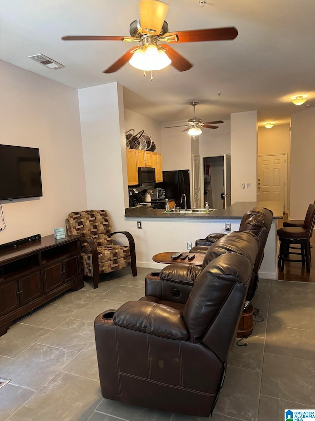 living room featuring light tile patterned flooring and sink