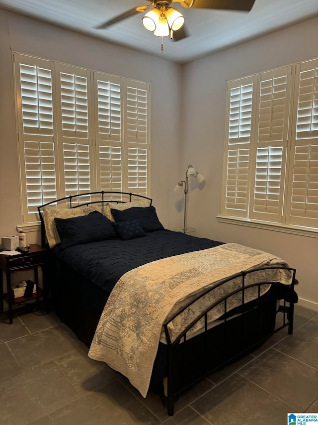 tiled bedroom with ceiling fan