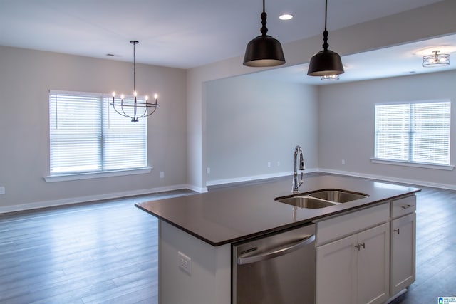 kitchen with pendant lighting, dishwasher, white cabinetry, and sink