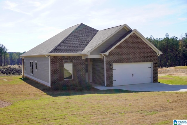 view of front of home with a front yard and a garage