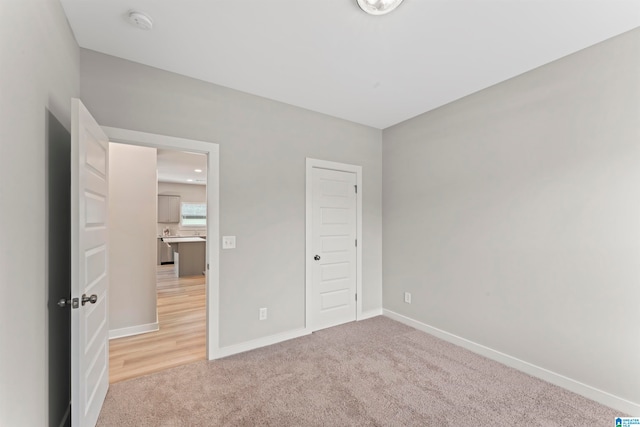 unfurnished bedroom featuring carpet flooring and a closet