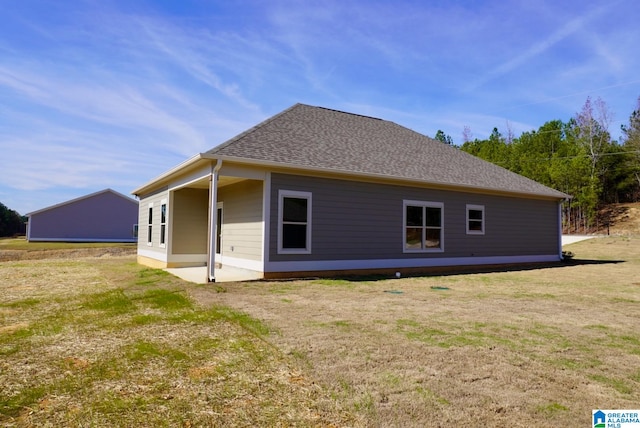 view of side of home with a lawn