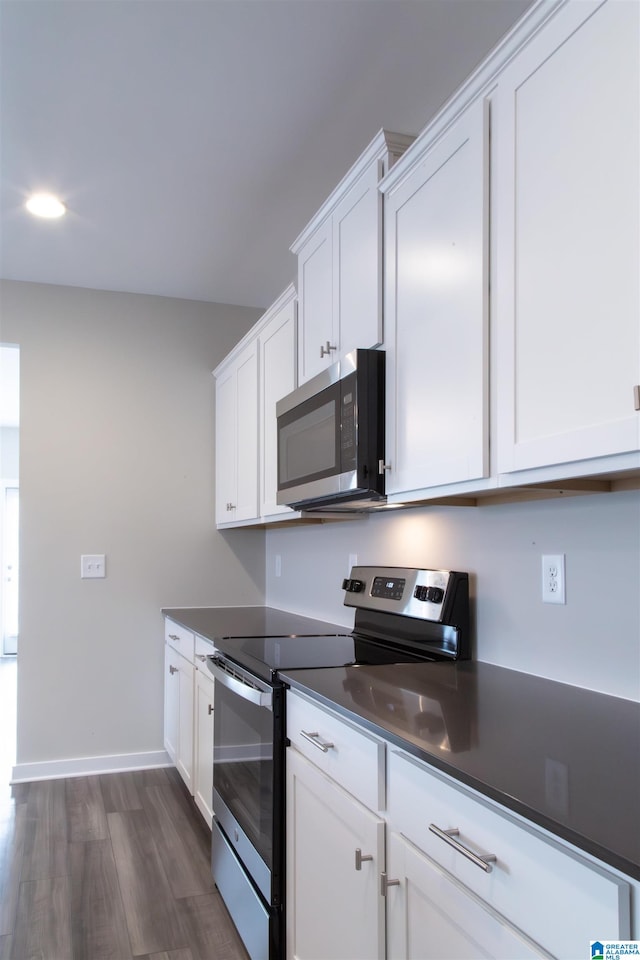 kitchen featuring dark hardwood / wood-style floors, white cabinetry, and appliances with stainless steel finishes