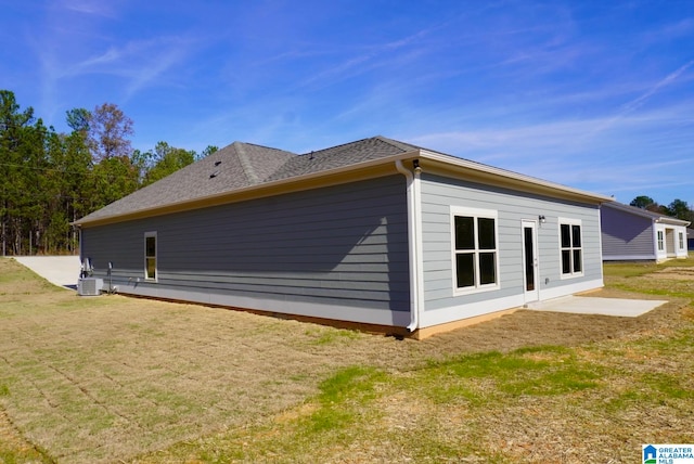 view of home's exterior with a yard and a patio area