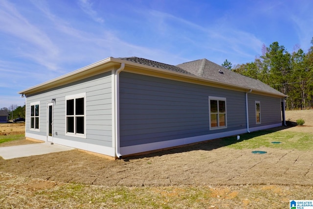 view of side of home featuring a patio area