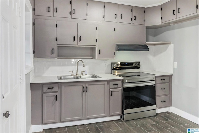 kitchen with stainless steel range with electric stovetop, backsplash, ventilation hood, sink, and dark hardwood / wood-style floors