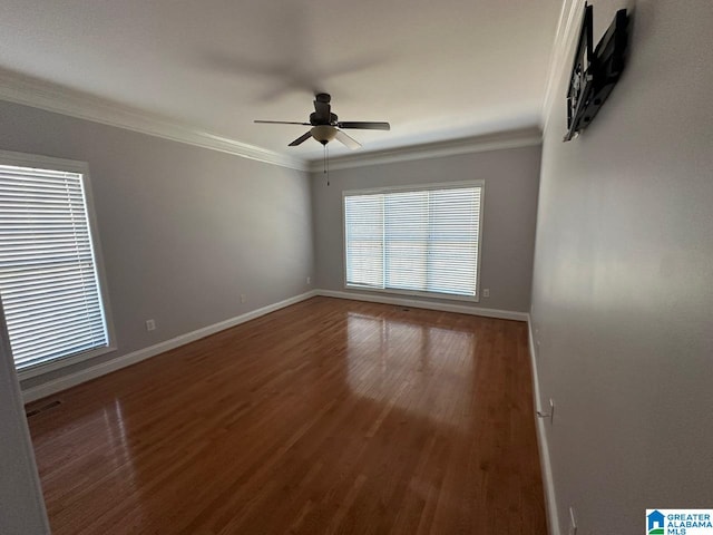 spare room featuring ceiling fan, wood-type flooring, and crown molding