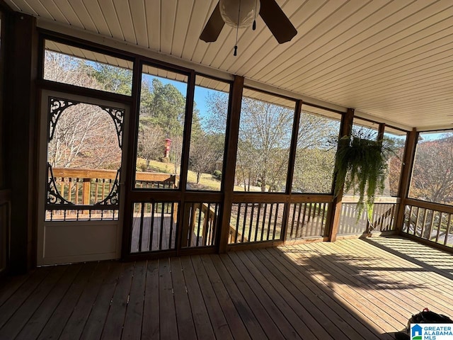 unfurnished sunroom featuring ceiling fan and wooden ceiling