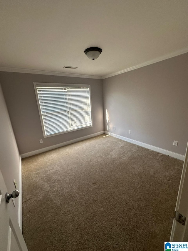 carpeted spare room with crown molding