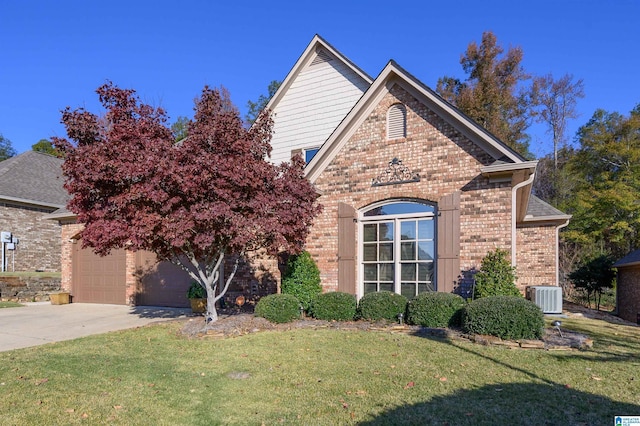 view of front of home featuring cooling unit, a garage, and a front lawn