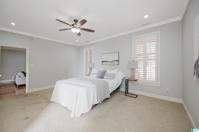 carpeted bedroom featuring ceiling fan and ornamental molding