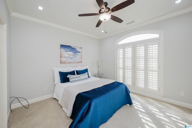 carpeted bedroom featuring ceiling fan and ornamental molding