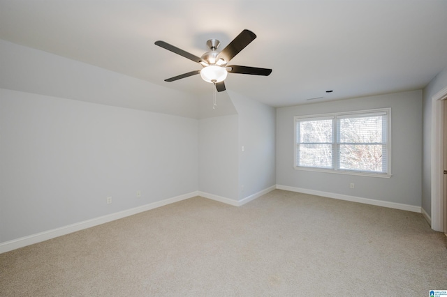 spare room with ceiling fan and light colored carpet