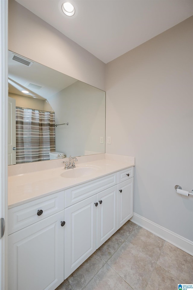 bathroom featuring vanity, tile patterned floors, and curtained shower