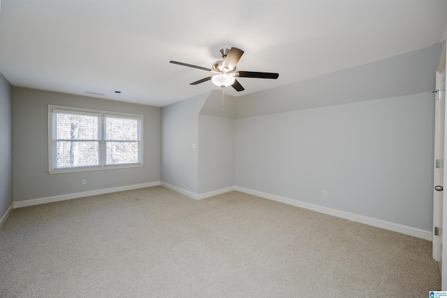 carpeted spare room with ceiling fan