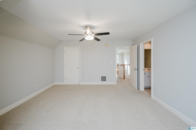 bonus room with ceiling fan, light colored carpet, and vaulted ceiling