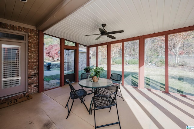 unfurnished sunroom featuring ceiling fan