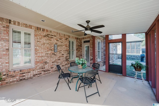 unfurnished sunroom with ceiling fan