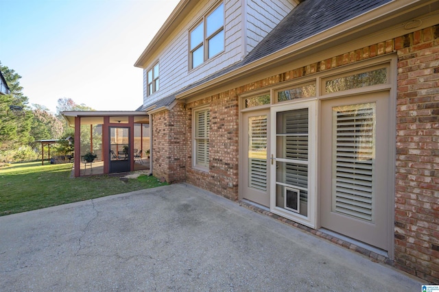 view of patio / terrace featuring a sunroom